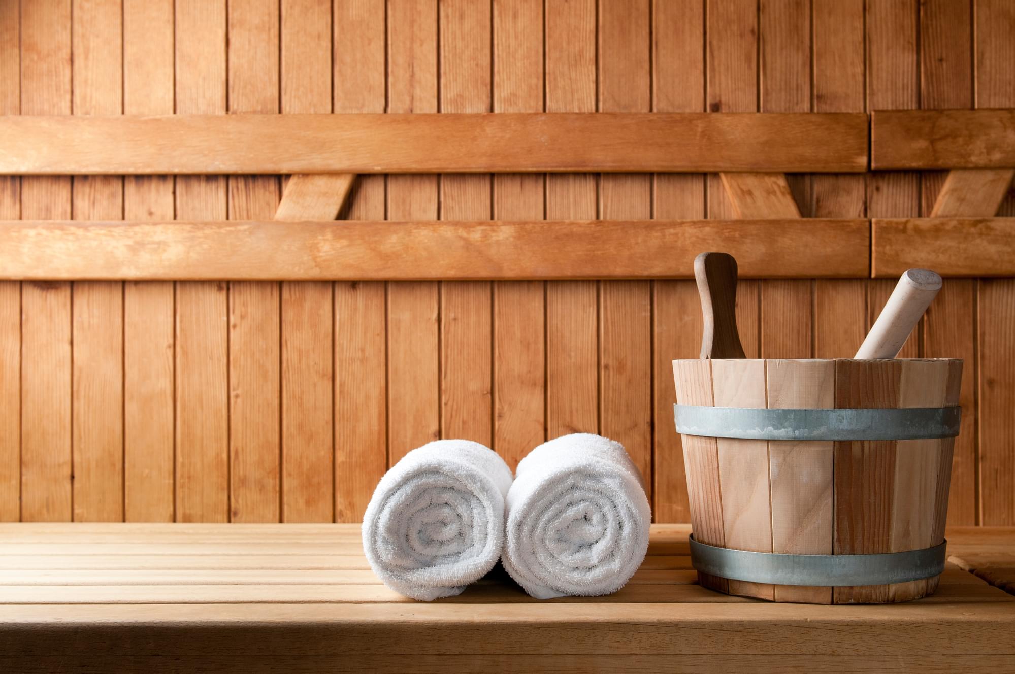 Detail of bucket and white towels in a sauna